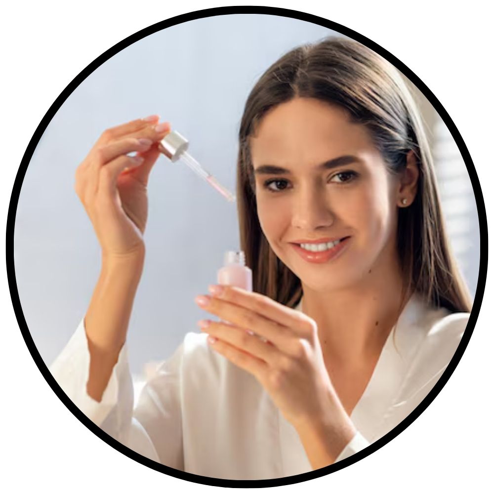 Woman holding a dropper bottle with a clear liquid against a light blue background